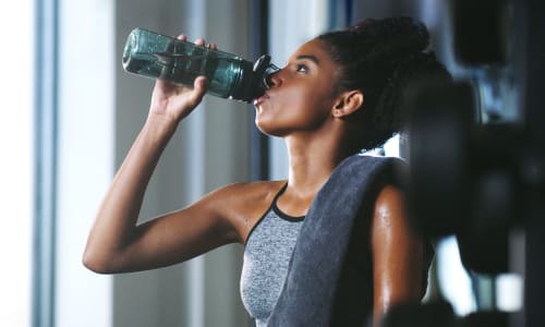 Resident drinking water in the fitness center at Amador Heights in Concord, California