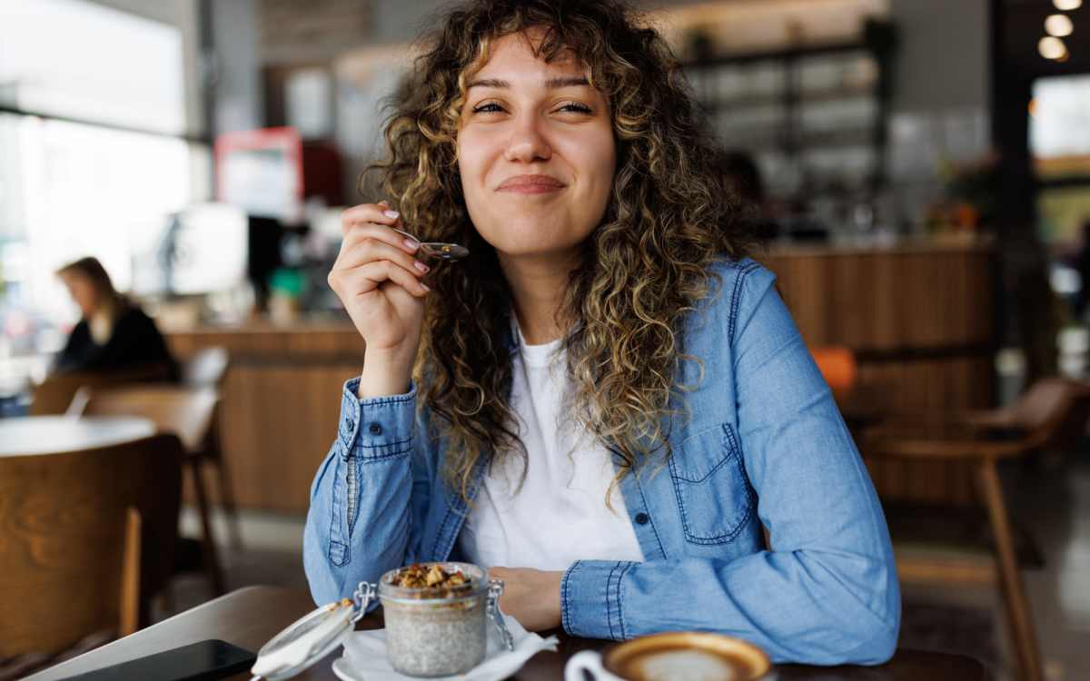 Resident woman having coffee at a restaurant near Pelican Isles Apartments in Sebastian, Florida