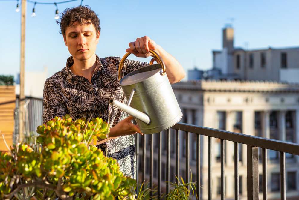 Resident watering his plant in his private balcony at Forest Creek in Oklahoma City, Oklahoma