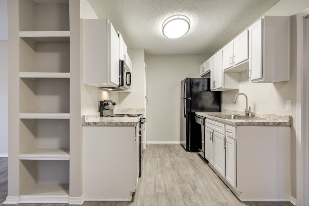 Extra storage next to the modern kitchen in a model home at The Arbors of Carrollton in Carrollton, Texas