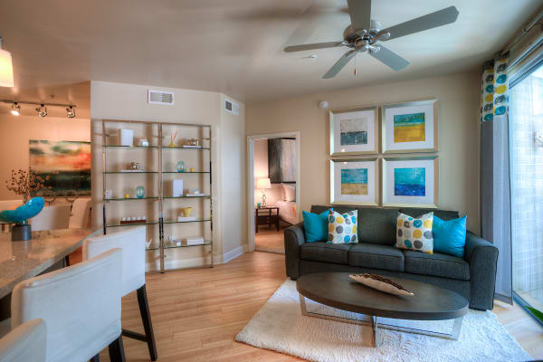 Open-concept living area with hardwood floors and ceiling fan in model home at Level at Sixteenth in Phoenix, Arizona