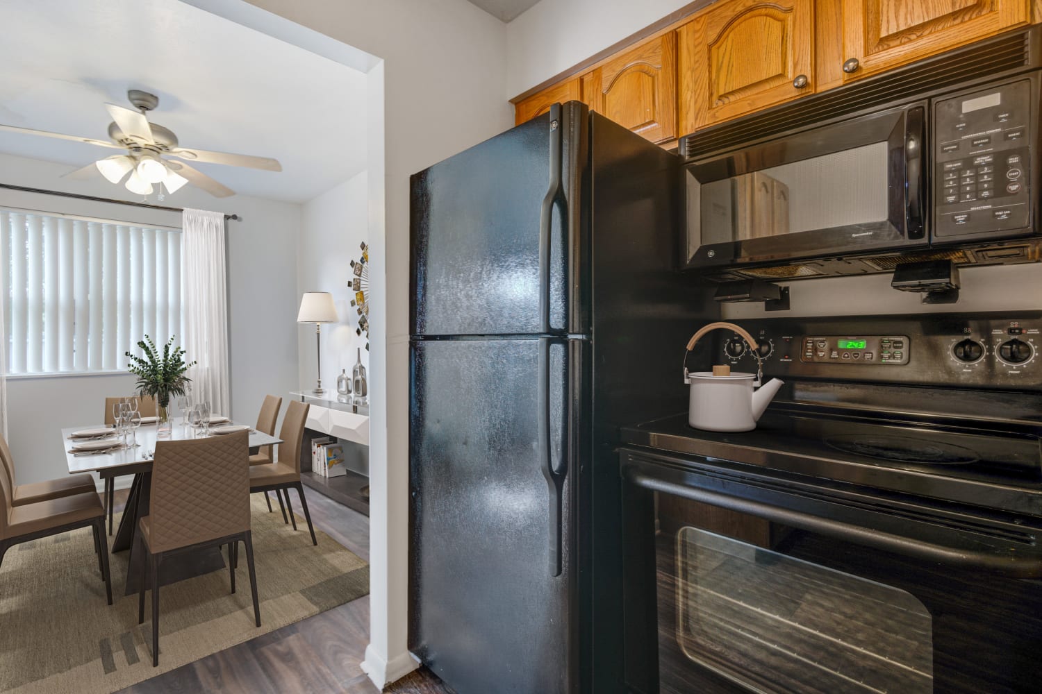 Kitchen with black appliances at Brighton Colony Townhomes in Rochester, New York