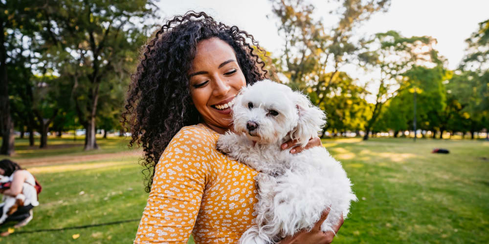 Happy resident and her puppy on a beautiful day at a park near Tides on Palm in Las Vegas, Nevada