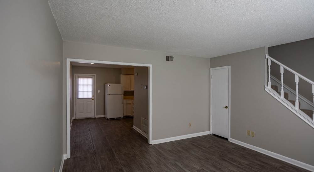 Cozy couch in a living room with wood-style flooring at Jackson Manor Apartments in Columbia, Tennessee