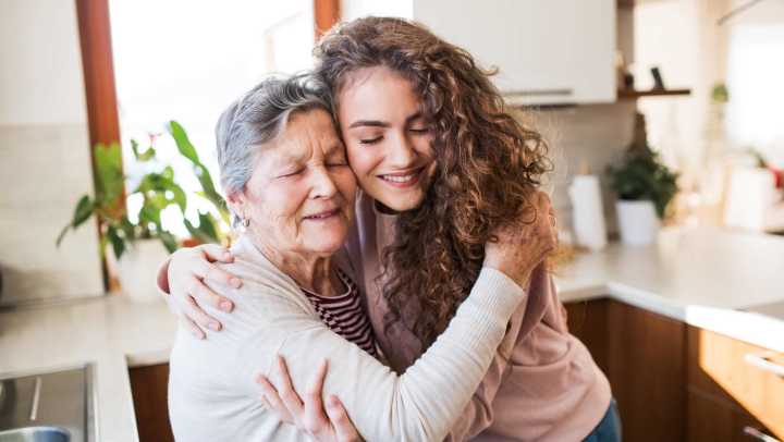 Grandma and her grandchild hugging each other at {{location_name}} in {{location_city}}, {{location_state_name}}