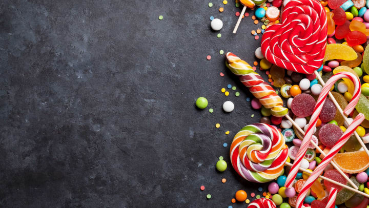 Colorful candies on stone background