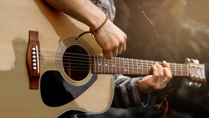 Close up of a person playing a guitar