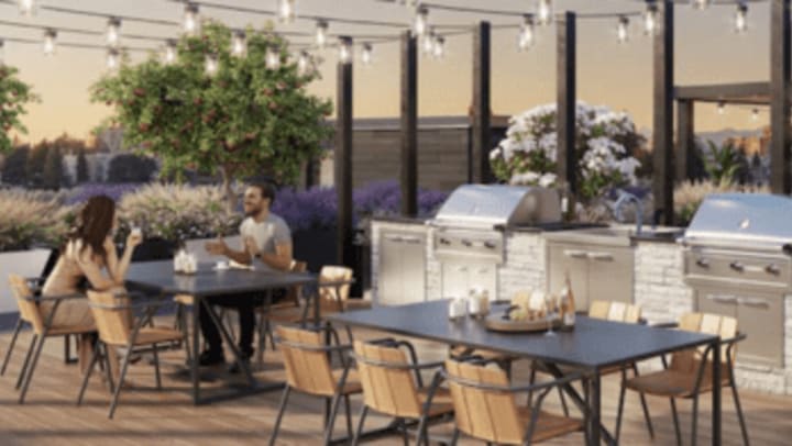 Couple sitting outdoor with grilling stations near them