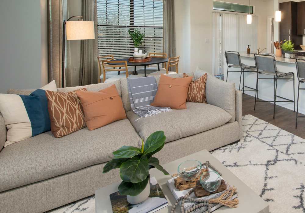 Living room with an pillows and center table at Nantucket at Fannin Station in Houston, Texas
