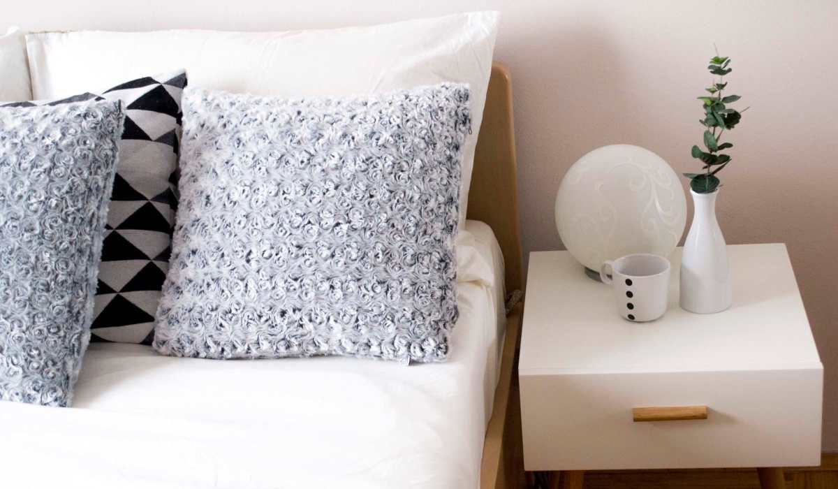 Bed and nightstand at Valencia South Miami in South Miami, Florida