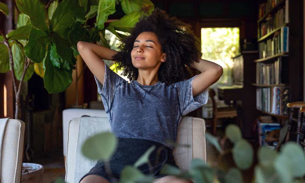 Resident relaxing at home with her plants at Flats at Stones Crossing in Greenwood, Indiana