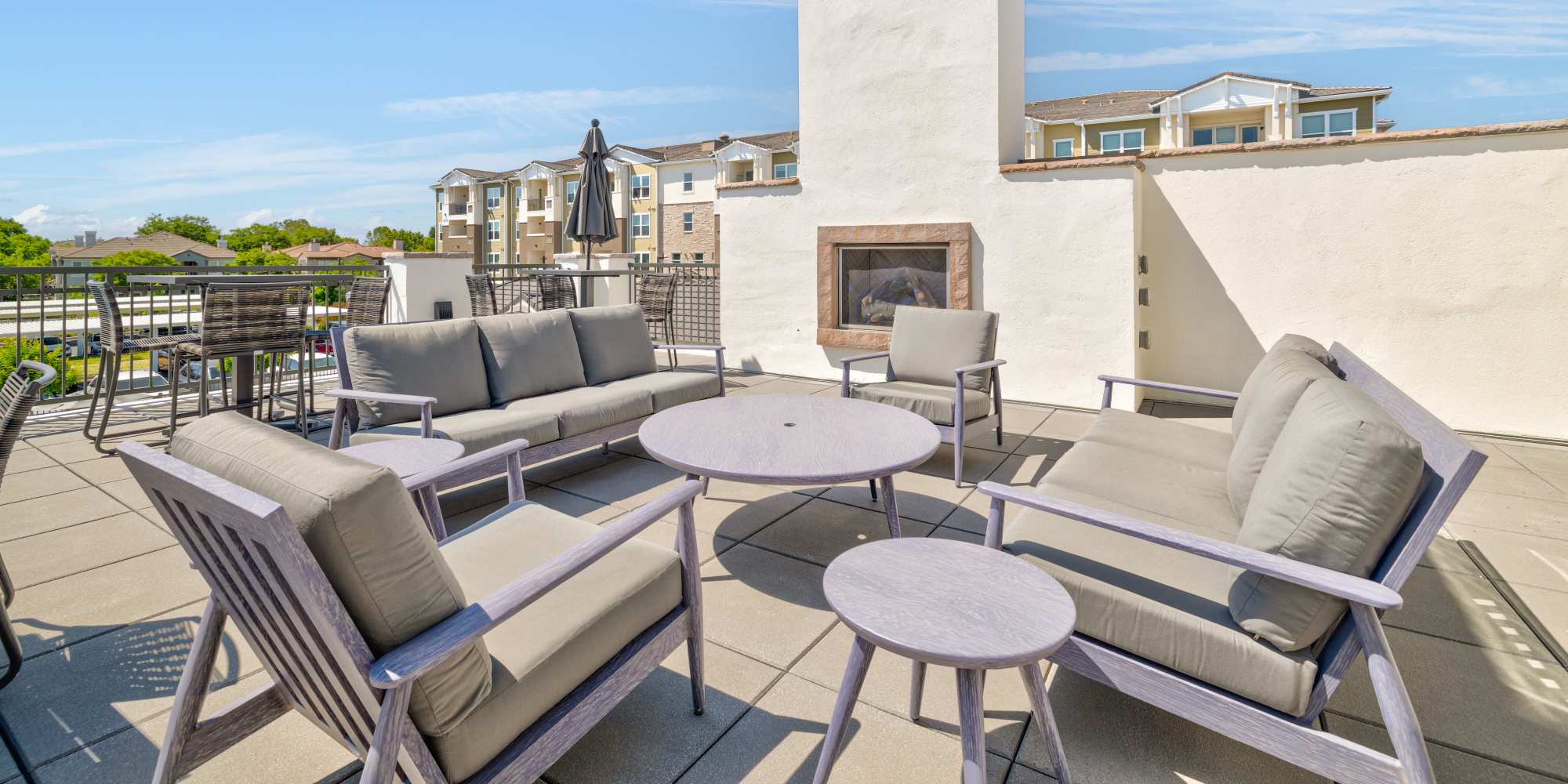 Outdoor seating and fireplace at Alira Apartments in Sacramento, California