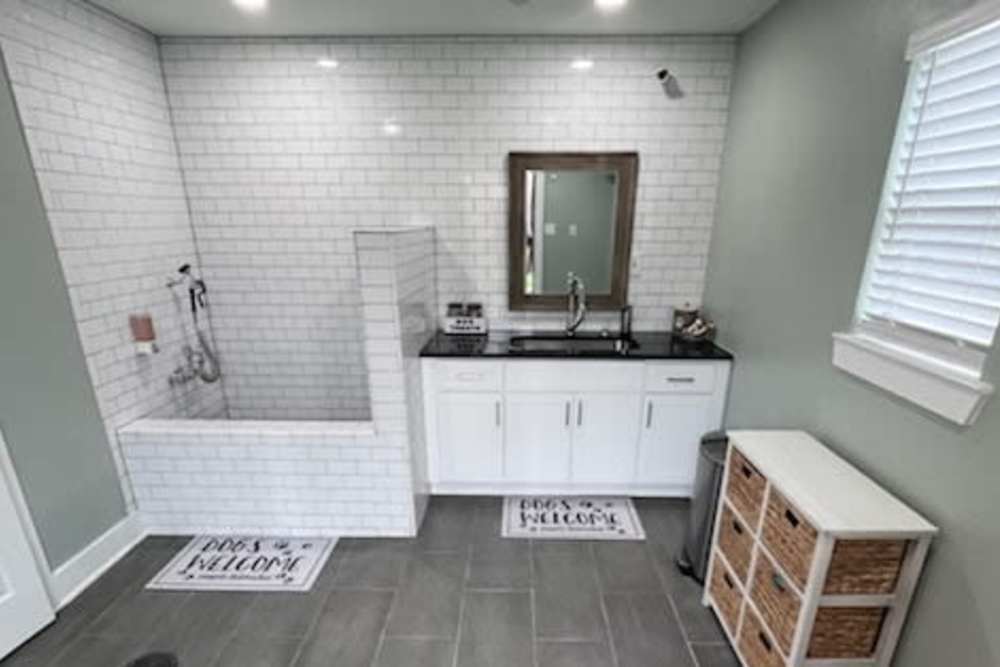 Dog wash in a tiled bathroom at The Abbey at Jones Road in Houston, Texas