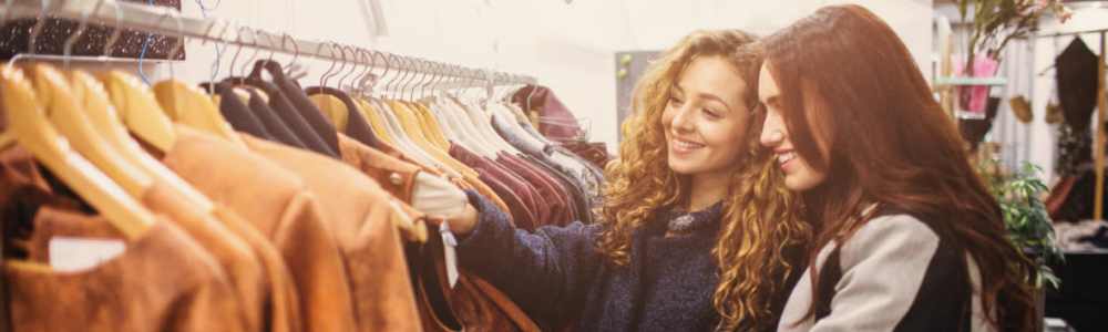 Resident couple shopping for clothes on racks at a downtown boutique near The District in Asheville, North Carolina