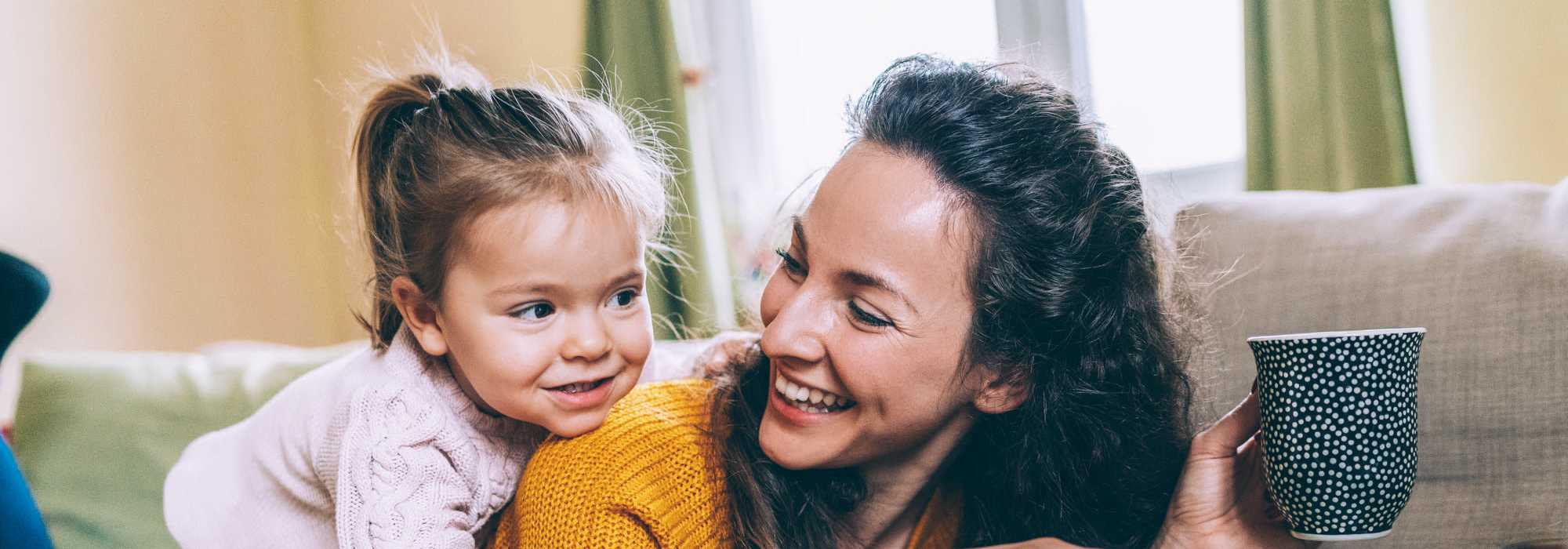 A woman and child sit together on a couch at Granite Creek in Rocklin, California.