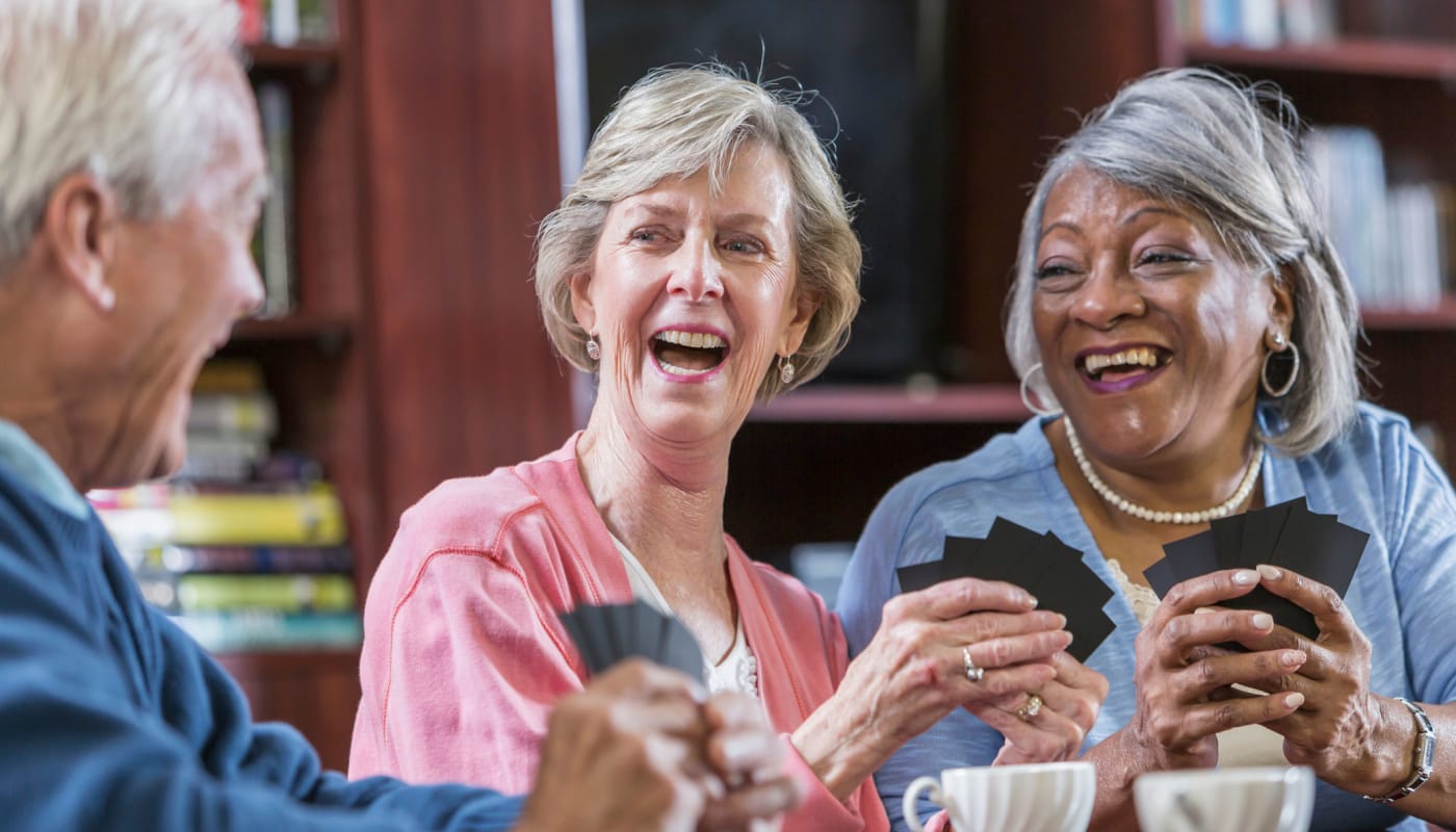 Residents playing cards with friends at Carolina Assisted Living in Appleton, Wisconsin.