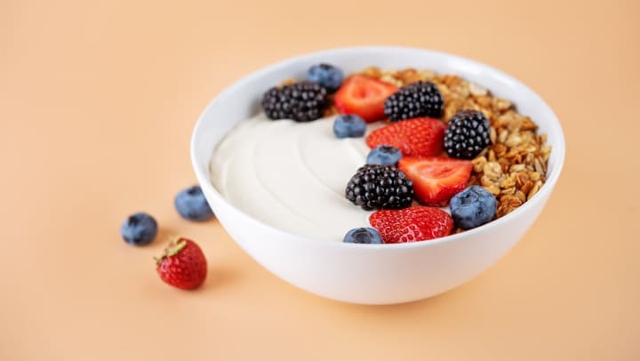 A bowl of homemade Greek yogurt with berries | DIY grocery hacks
