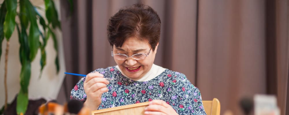 A resident painting at Ridgeline Management Company senior living property