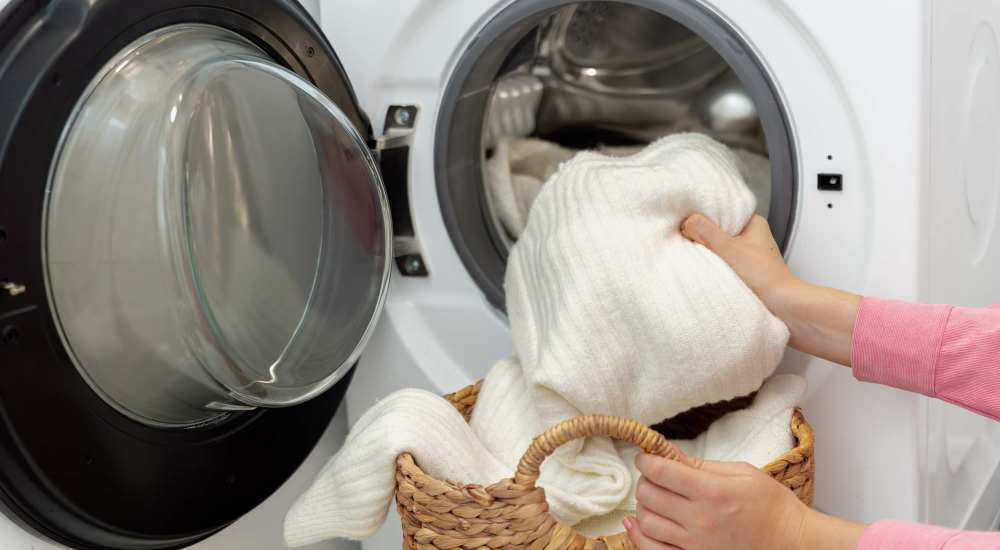 Resident unloading her washing machine at Huntington Reef in Huntington Beach, California