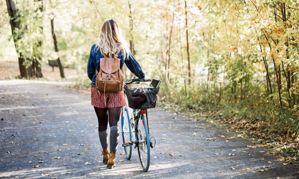 Student walking their bike to school near Apple Creek Apartments in Stillwater, Oklahoma