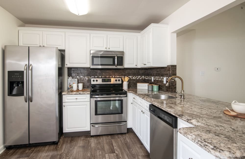 Fully equipped kitchen with stainless steel appliances in a home at Abrams Run Apartment Homes in King of Prussia, Pennsylvania