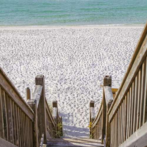 Wooden stairs leading to a beach near Artisan Living North Beach in Santa Rosa Beach, Florida