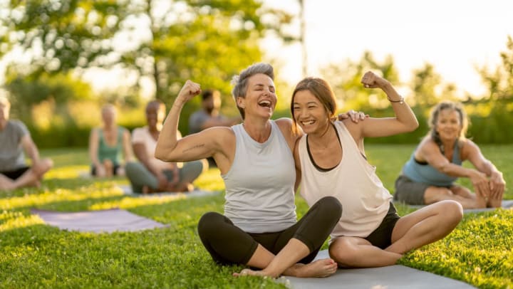 Senior woman and young woman doing yoga together