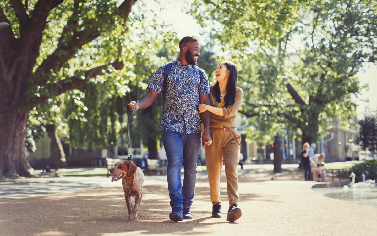 Residents walking their dog through a park near The Grove at Oakbrook in Summerville, South Carolina