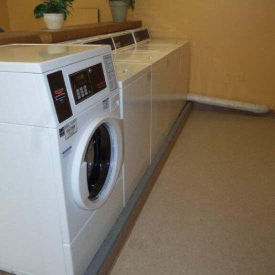 Laundry room with washer and dryer at Los Flamboyanes in Rochester, New York