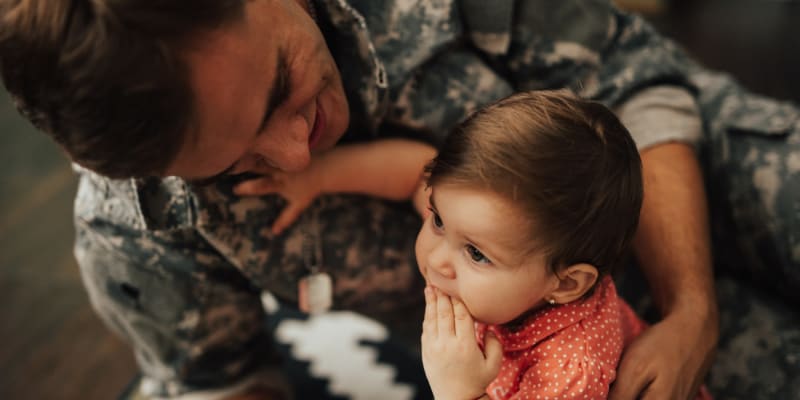 A father holding his daughter at Discovery Village in Joint Base Lewis McChord, Washington