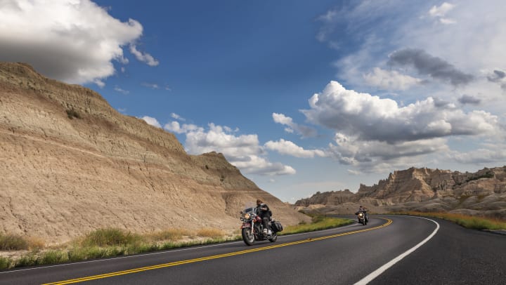A person riding a motorcycle along a highway