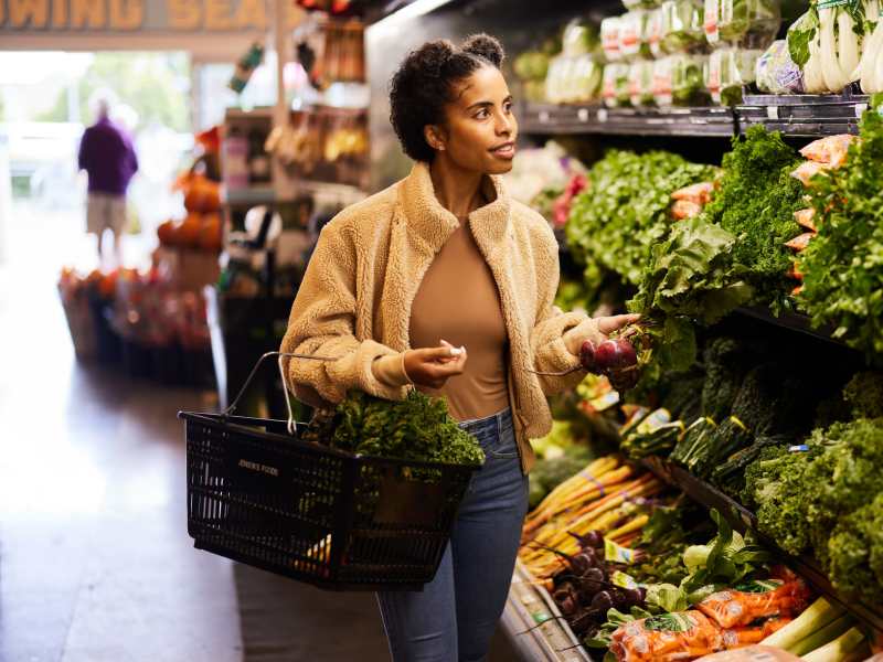Resident buying fresh fruits and veggies at a market near One West Hartford in West Hartford, Connecticut