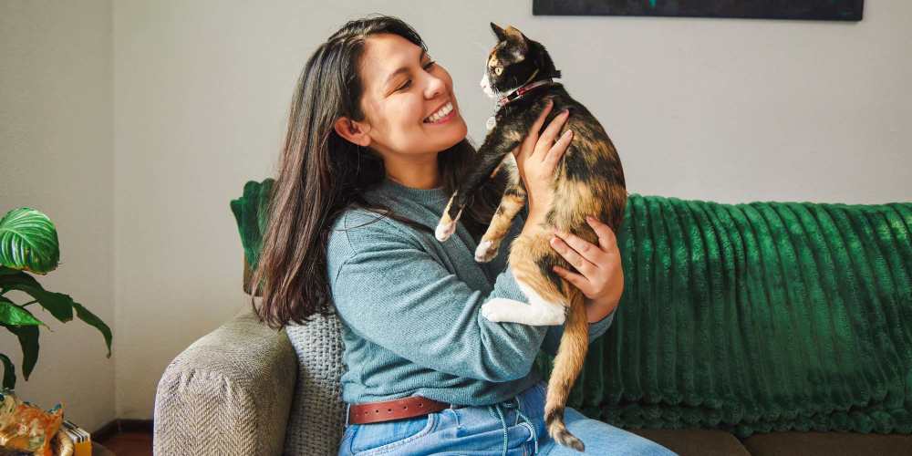 Happy resident with her pet at Icon Park in Sterling Heights, Michigan