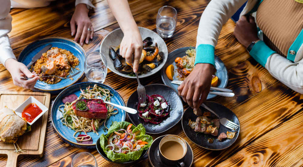 Group of residents enjoying wide range of food items at a restaurant near The Element At Wilma Rudolph in Clarksville, Tennessee