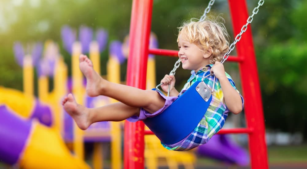 Kid in a swing in a playground near Davis Park in Smyrna, Tennessee