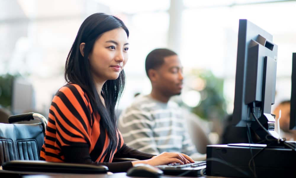 Friends working on thier desktop at Mazza Grandmarc in College Park, Maryland