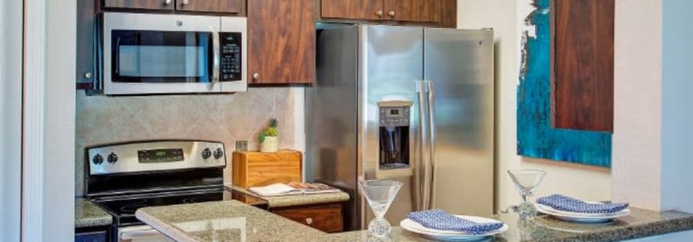 A kitchen with stainless-steel appliances at The Fuse at Park Row in Houston, Texas