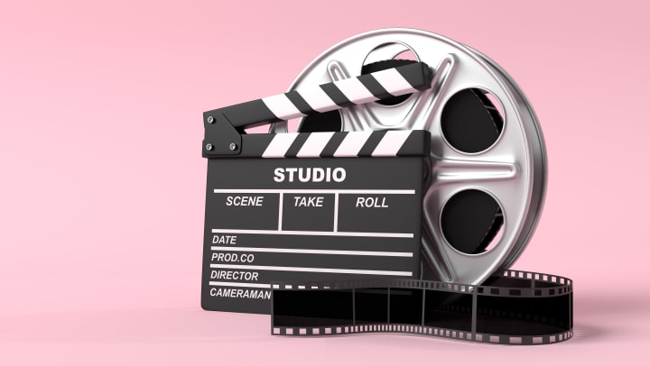 Film reel with clapperboard isolated on bright pink background in pastel colors
