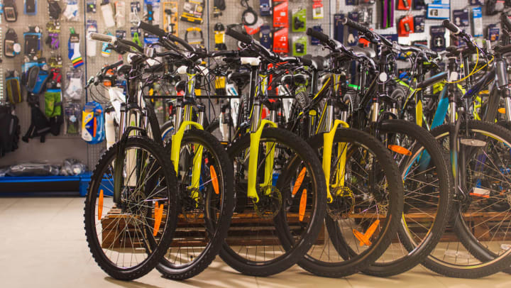 a row of 8 bicycles lined up in a bike shop| bike shops around Phoenix