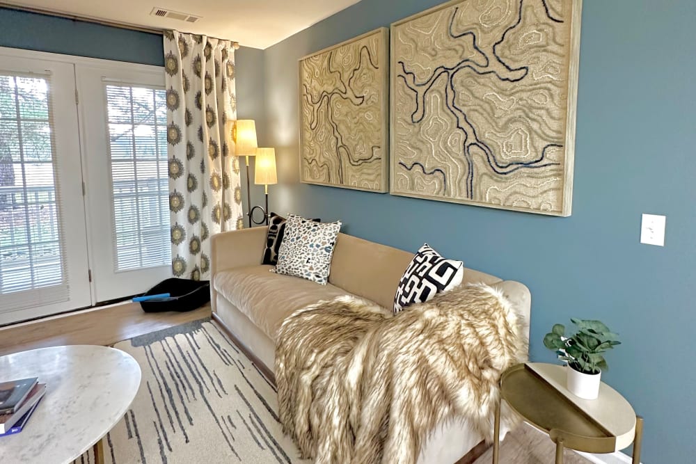 Large master bedroom with white couch at Glade Creek Apartments in Roanoke, Virginia