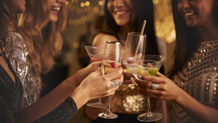 Group of women clinking their cocktail glasses,