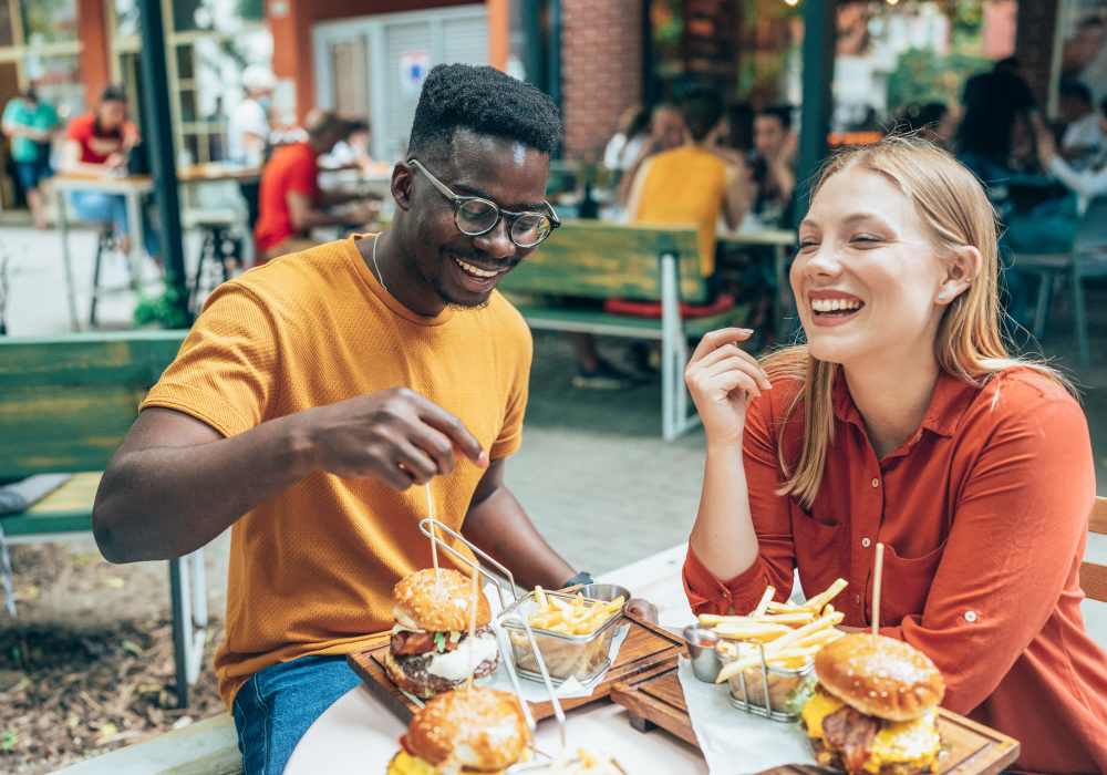 Friends having  burgers near Charleston at Fannin Station in Houston, Texas