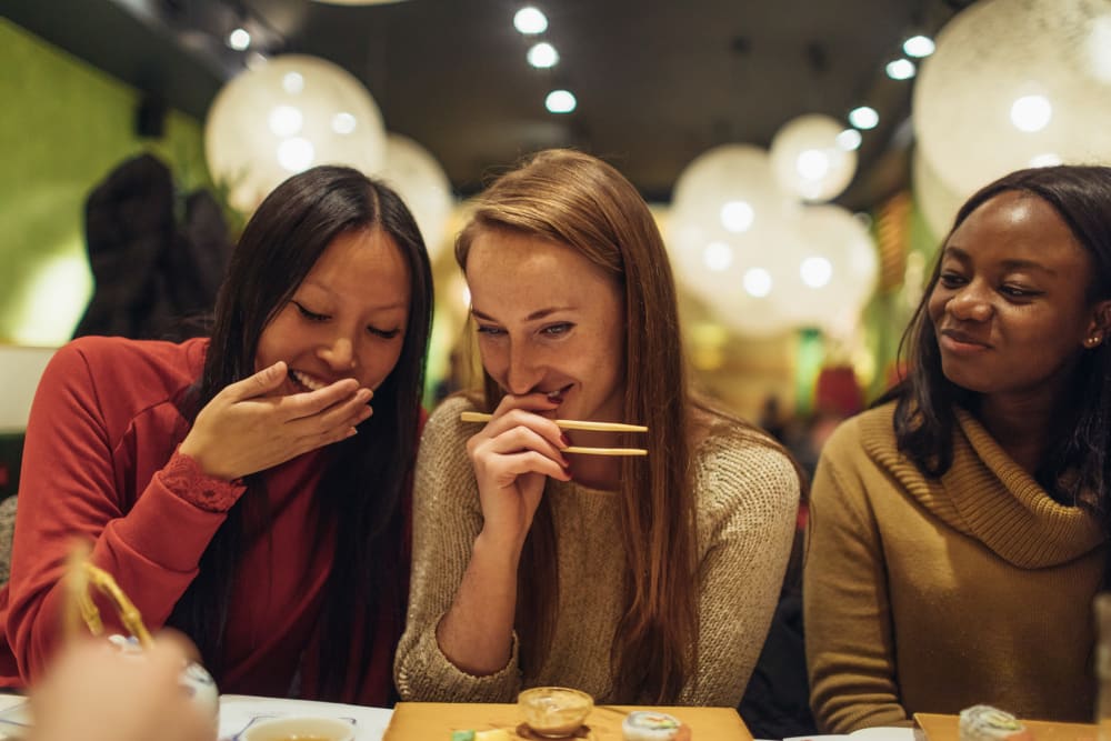 Friends eating together at State Gardens in Hackensack, New Jersey