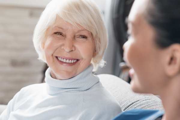 Caregiver reviews SafelyYou AI fall detection footage from a discreet camera in a senior resident’s room.