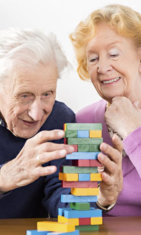 Senior couple playing jenga at The Phoenix at Savannah in Savannah, Georgia