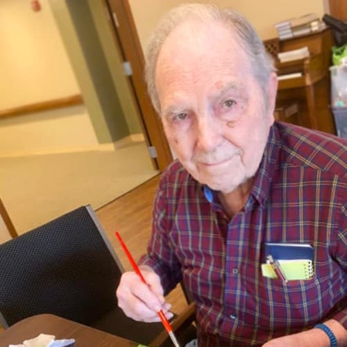 Resident painting at Oxford Glen Memory Care at Sachse in Sachse, Texas