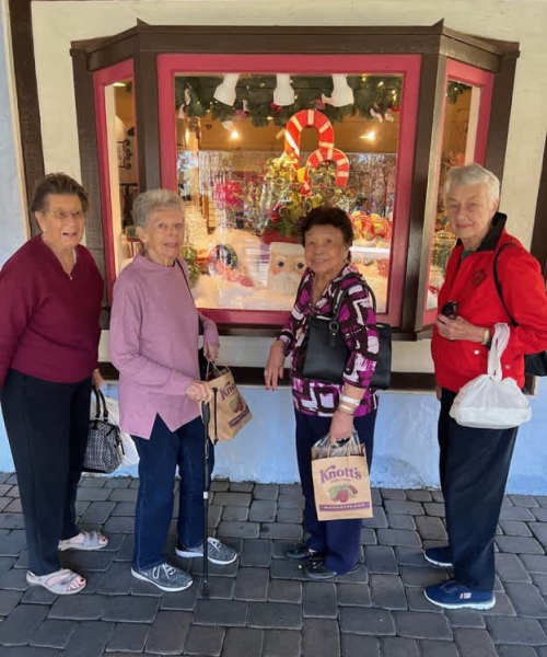 Residents taking a group photo for a Holiday Open House event