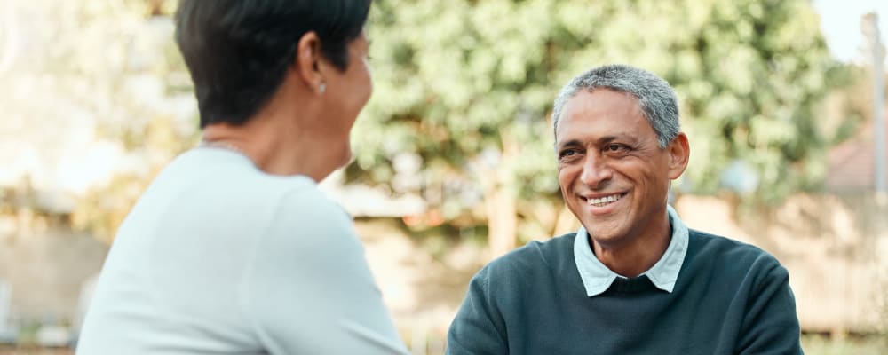 A resident smiling at a staff member at Ridgeline Management Company in Rockwall, Texas