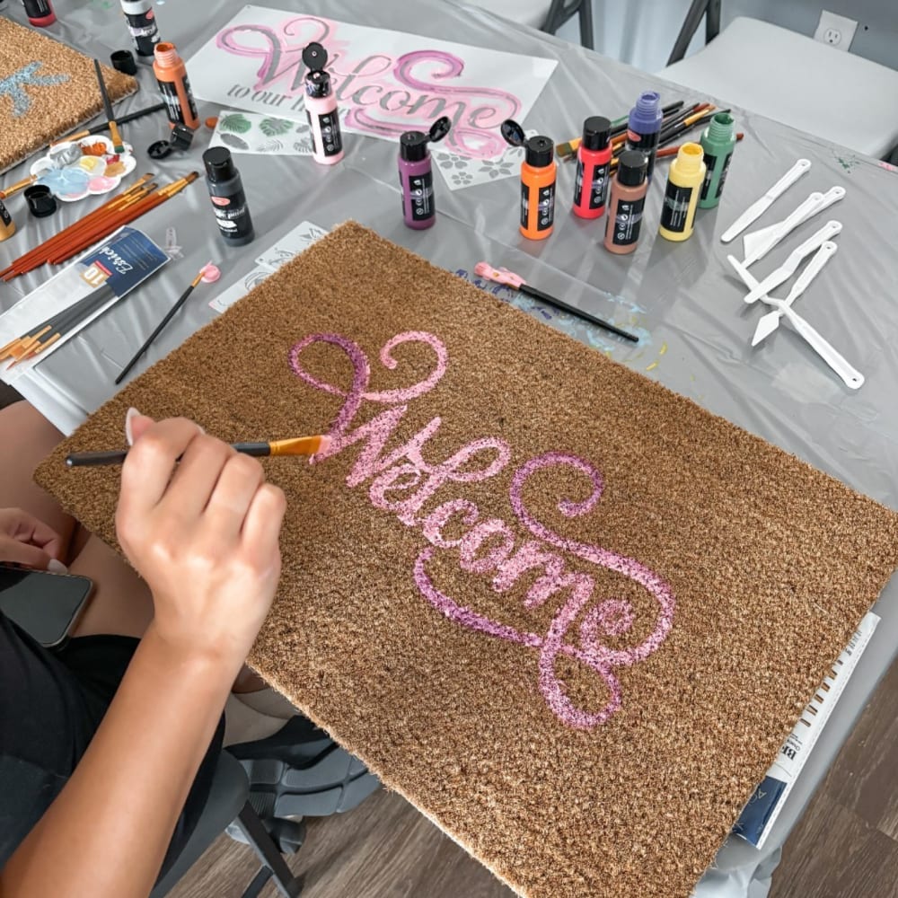 Welcome mat painting at The Landing St. Louis in Saint Louis, Missouri