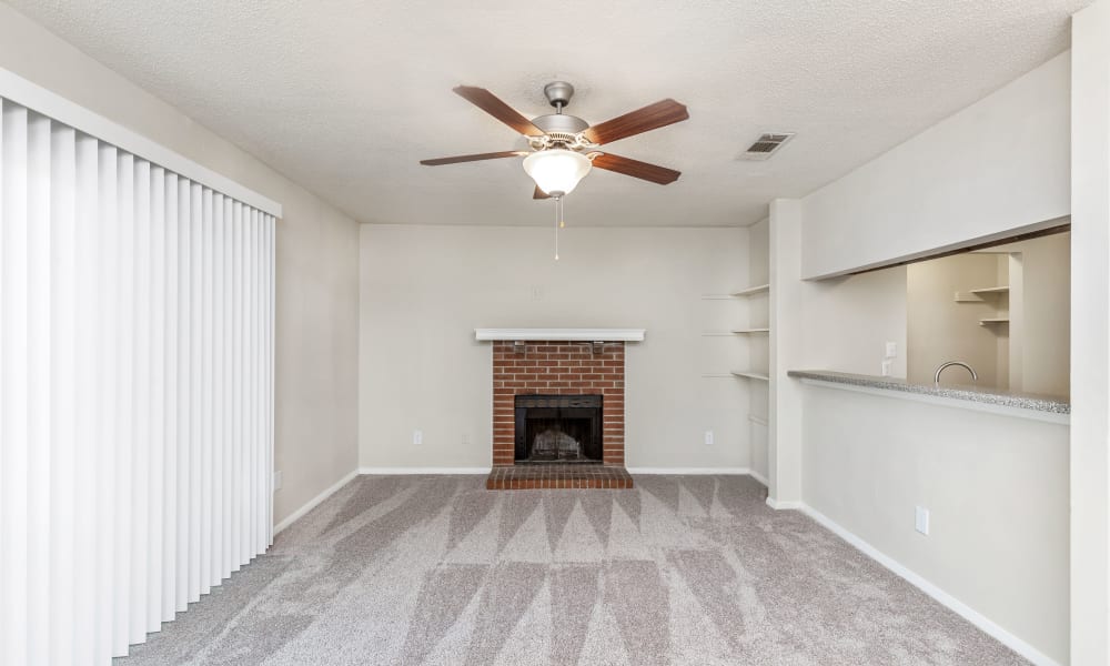 Bright living room with a ceiling fan at Austell Village Apartment Homes in Austell, Georgia